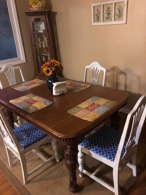All four refinished chairs around the unfinished table.