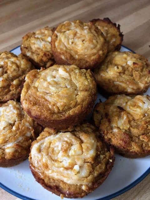 A plate of yummy pumpkin cream cheese muffins.